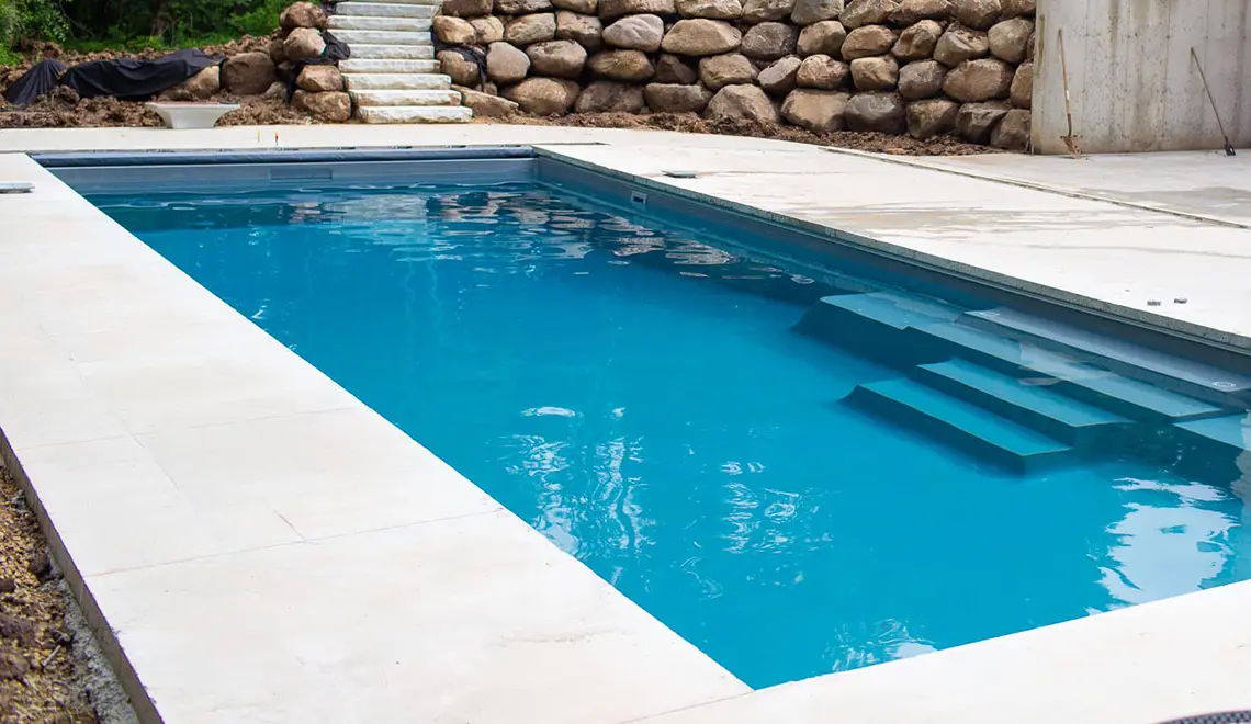 Leisure Pools The Grand rectangular fiberglass pool side view by Leisure Pools Boston North